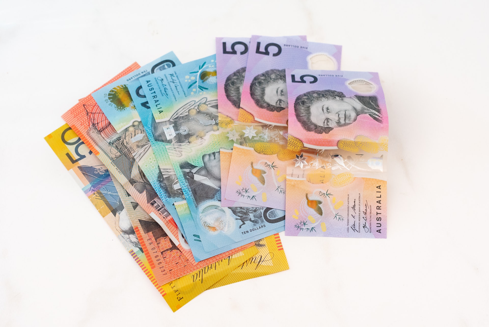 Australian cash notes laid out on a white background.